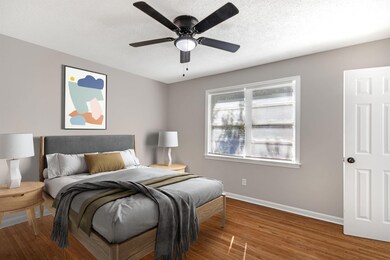 Bedroom featuring a textured ceiling, hardwood / w
