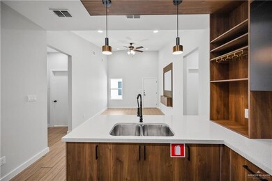 Kitchen with a sink, visible vents, and light countertops