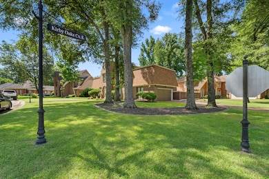 View of front of property with a garage, a front lawn, and a residential view