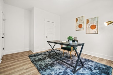 Office area featuring baseboards and wood finished