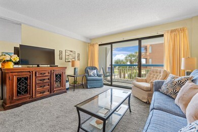 Carpeted living area with a textured ceiling