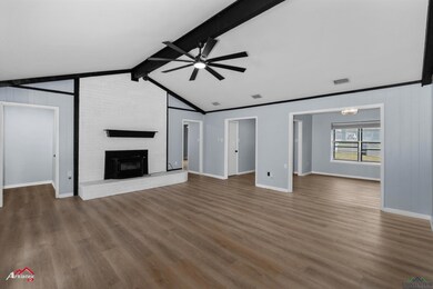 Unfurnished living room with a fireplace, vaulted 