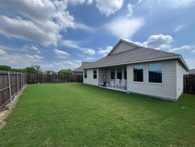 Back of property featuring a yard