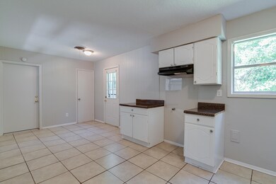 Kitchen featuring light tile patterned flooring an