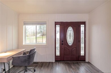 Office area/entry hall's large windows overlook th