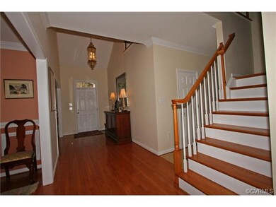Two story foyer with hardwood floor, half bath, ga
