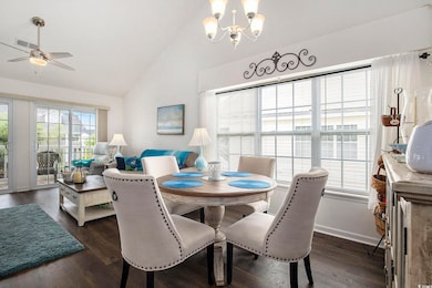 Dining space with a chandelier, a ceiling fan, dar