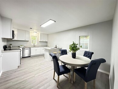 Dining space featuring sink and light hardwood / w
