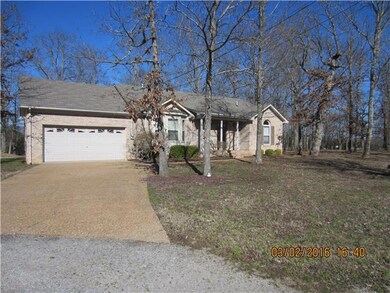 View of Property showing Pea Gravel Drive leading into 2 Car Garage