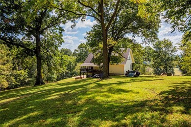 A beautiful back yard with a covered back deck to sit and enjoy the sounds of the birds and watch the wildlife that wonders across the back yard.