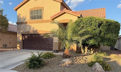 View of front of home with a tile roof, a garage,