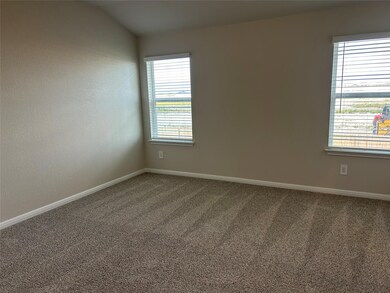 Carpeted empty room with baseboards
