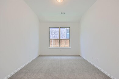 Carpeted spare room with vaulted ceiling
