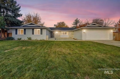 Ranch-style house with a chimney, a yard, concrete driveway, an attached garage, and a patio