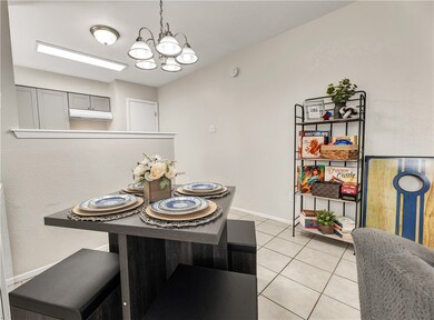 Tiled dining room with an inviting chandelier