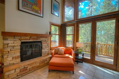 Handsome rock hearth anchors the sunny great room.