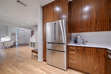 Kitchen featuring stainless steel fridge and  wood