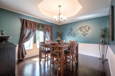 Elegant Dining Room with Hardwoods and Wainscoatin