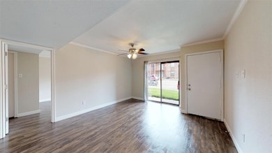 Spare room with crown molding, wood finished floor