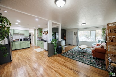 Living room with light wood-style floors and a textured ceiling