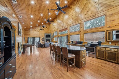 Kitchen featuring stone counters, appliances with 