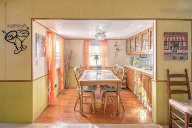 Dining room with bar area, crown molding, and ligh