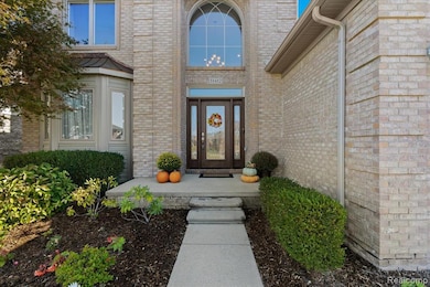 View of exterior entry featuring brick siding