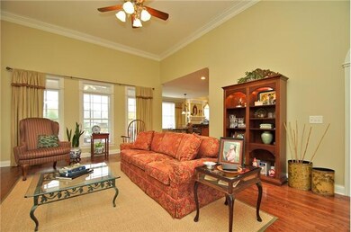 Another view of Large Open Living Room featuring High Ceilings, Fireplace & Wall of Windows looking To Cozy Screened in Porch.