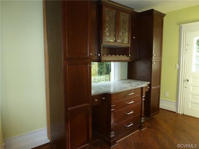 Gorgeous, grand, and unique to the home...great upgrade with plenty of cabinets and wine rack. Door to Rear Patio with Stamped Concrete Patio.