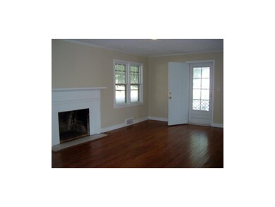 Gleaming hardwood floors, fireplace and exit to sc