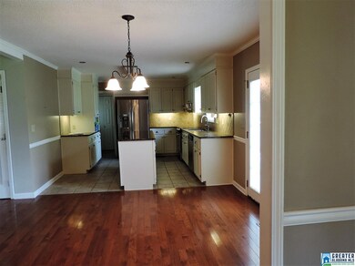 Beautiful hardwood floors in eat in area in kitche