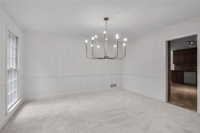 Dining Room with crown molding and a chandelier