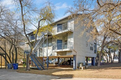 View of front of home with a carport, stairs, a b