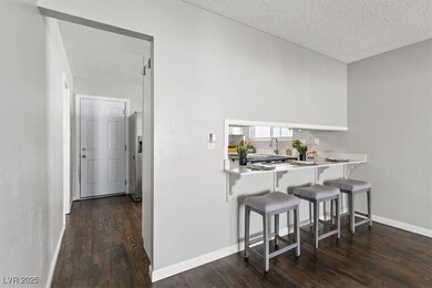 Kitchen featuring dark wood-style floors, a kitche