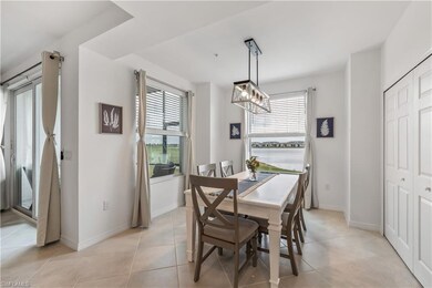 Tiled dining room featuring a water view and a cha