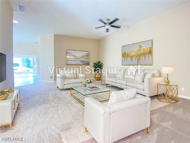 Carpeted living room featuring ceiling fan