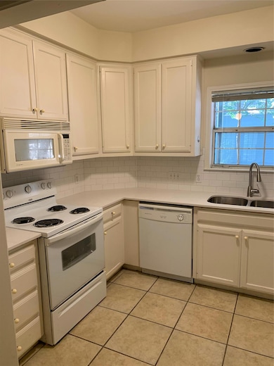 Kitchen featuring a sink, decorative backsplash, 