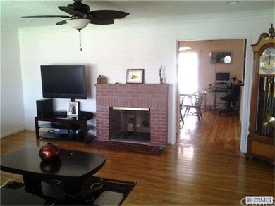 Open living room dual fireplace to dining room are