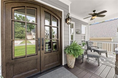 Entrance to property featuring french doors, a porch, and ceiling fan