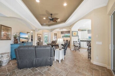 Living room featuring ceiling fan, a wealth of nat