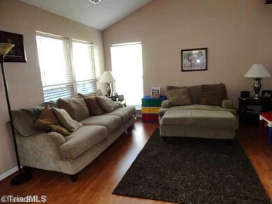 Living Room. Living Room Features New Laminate Wood Flooring & Vaulted Ceiling