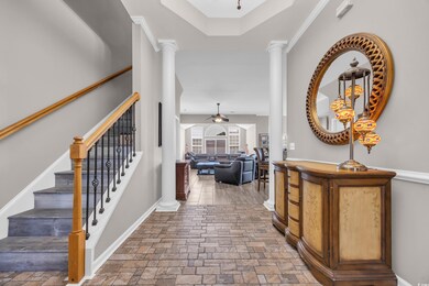 Entrance foyer with decorative columns and Chandelier