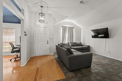 Living room with lofted ceiling and dark wood-type