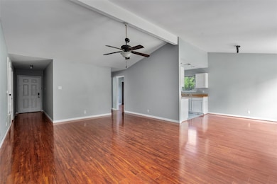 Unfurnished living room featuring wood finished f