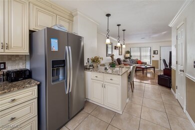 Kitchen featuring cream cabinetry, stainless steel