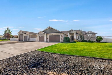 Craftsman-style home with board and batten siding, a garage, driveway, and stone siding