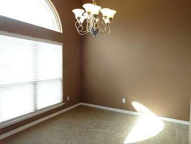 Dining Room. Neutral tile, large window and wonderful lighting = perfect Formal Dining area.