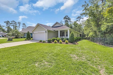 Single story home featuring an attached garage, concrete driveway, and a porch