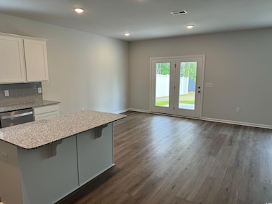 Kitchen with light stone countertops, baseboards, 