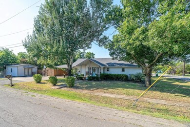 Ranch-style home with an outbuilding and a front yard
